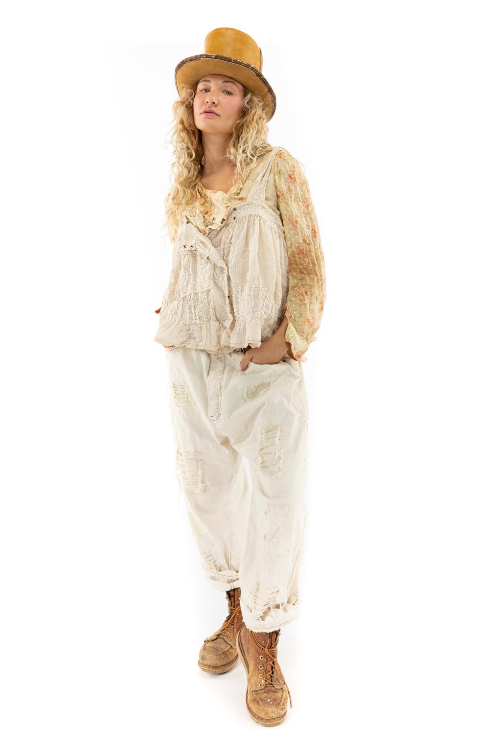Magnolia Pearl model in artisan vintage distressed overalls, floral blouse, and whimsical top hat