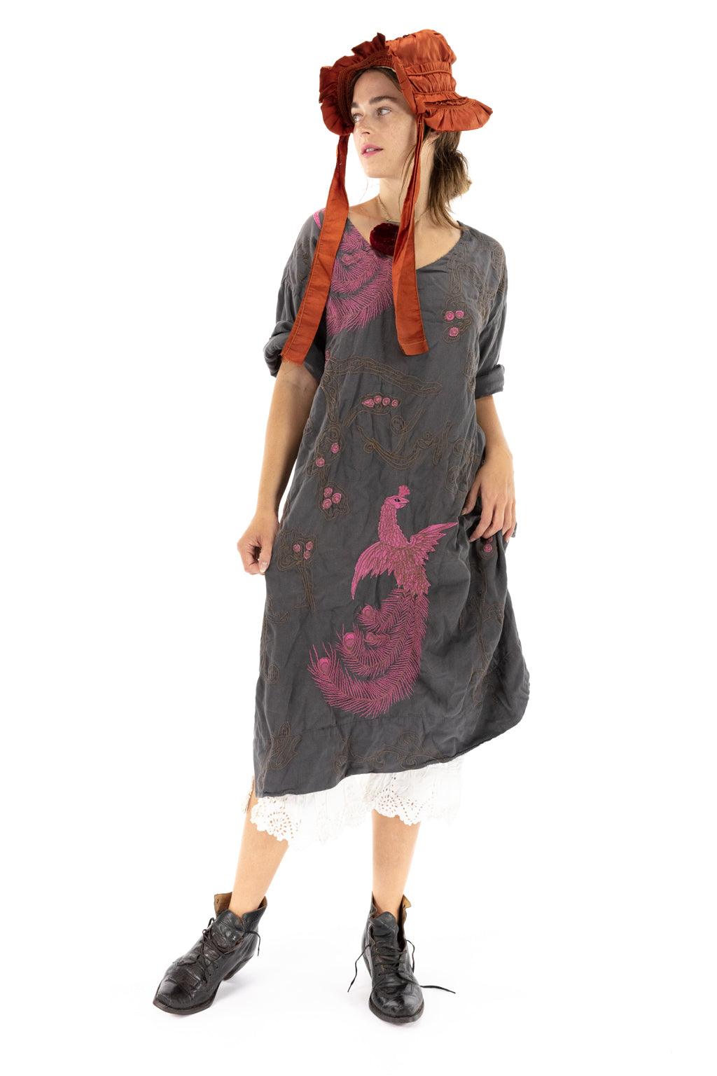 Magnolia Pearl artisan vintage dress with whimsical pink bird design, worn with lace trim and bonnet