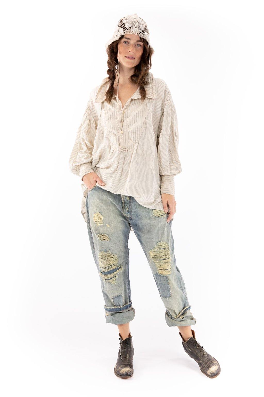 Woman wearing Magnolia Pearl artisan vintage-style blouse, distressed jeans, lace hat, and boots