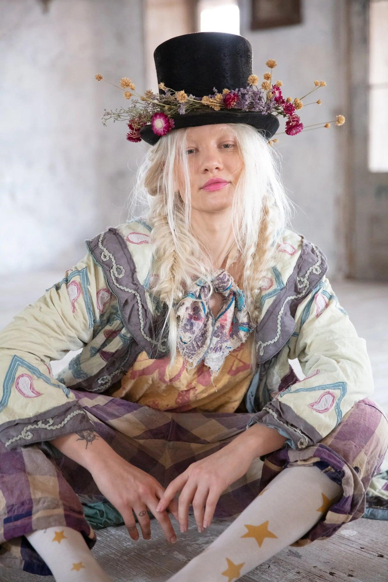 Woman in Magnolia Pearl artisan vintage jacket, floral top hat, whimsical eclectic clothing style